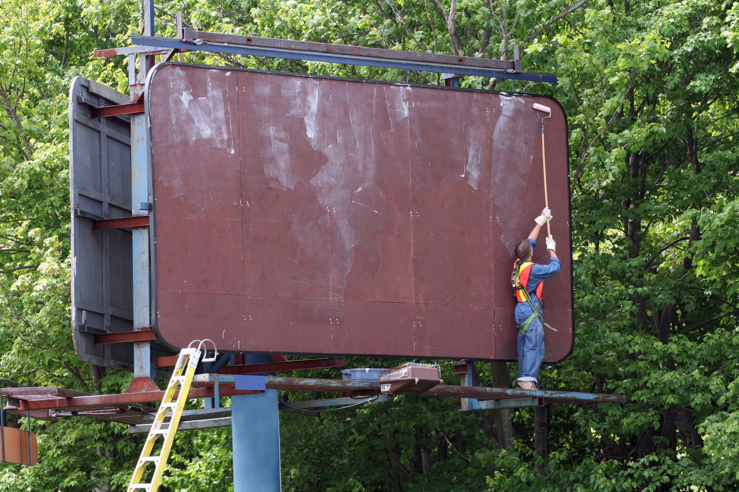 Which adhesives work well for mounting posters on billboards?